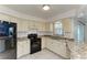 Practical kitchen with a classic design, granite countertops, and modern appliances at 1346 Queen Rd, Venice, FL 34293