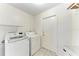 Laundry room with front-load washer and dryer, tiled floor, and white walls at 1346 Queen Rd, Venice, FL 34293