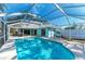 Inviting screened-in pool area with lounge chairs and a well-maintained backyard at 1346 Queen Rd, Venice, FL 34293