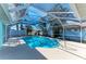 Private screened-in pool area surrounded by palm trees at 1346 Queen Rd, Venice, FL 34293