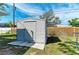 Backyard shed with concrete base, set against a wood fence and grassy area at 1346 Queen Rd, Venice, FL 34293