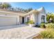 Charming home with paver driveway, two-car garage, neutral paint scheme and attractive landscaping at 1359 Tearose Pl, Sarasota, FL 34239