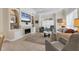 Comfortable living room featuring a fireplace, built-in shelving, and neutral tile floors at 1359 Tearose Pl, Sarasota, FL 34239