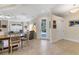 Bright and airy living space with neutral tile floors, dining table, and doorway to back patio at 1359 Tearose Pl, Sarasota, FL 34239