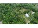 Aerial view showing home nestled in lush, green surroundings at 14018 Pine Woods E Ln, Sarasota, FL 34240