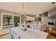 Bright dining area with chandelier and backyard view at 14018 Pine Woods E Ln, Sarasota, FL 34240