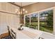 Charming dining area with chandelier and view of the backyard at 14018 Pine Woods E Ln, Sarasota, FL 34240