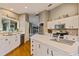 Kitchen with white cabinets, island and stainless steel appliances at 14018 Pine Woods E Ln, Sarasota, FL 34240