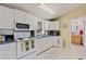 Cozy kitchen with white cabinets and modern appliances at 14018 Pine Woods E Ln, Sarasota, FL 34240