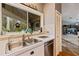 Kitchen features a double sink and white cabinets at 14018 Pine Woods E Ln, Sarasota, FL 34240