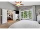 Main bedroom with walk-in closet, large window, and ceiling fan at 14018 Pine Woods E Ln, Sarasota, FL 34240