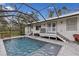 Screened pool and spa with adjacent deck and house access at 14018 Pine Woods E Ln, Sarasota, FL 34240