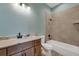 Clean bathroom with light teal walls, walk-in shower, and modern vanity at 144 Spring Dr, Rotonda West, FL 33947