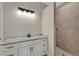 Bathroom with white vanity, marble countertop and shower at 144 Spring Dr, Rotonda West, FL 33947