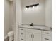 Bathroom with white vanity, marble countertop and toilet at 144 Spring Dr, Rotonda West, FL 33947