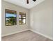 Simple bedroom with wood-look floors and two large windows at 144 Spring Dr, Rotonda West, FL 33947