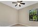 Simple bedroom with wood-look floors and large window at 144 Spring Dr, Rotonda West, FL 33947