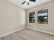 Well-lit bedroom featuring wood-look floors and large windows at 144 Spring Dr, Rotonda West, FL 33947