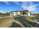 Two-car garage and welcoming front yard with landscaping at 144 Spring Dr, Rotonda West, FL 33947