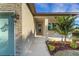 Inviting front porch with light colored stone and a lush tropical landscaping at 144 Spring Dr, Rotonda West, FL 33947