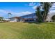 Landscaped backyard with pool and screened enclosure at 1441 Gleneagles Dr, Venice, FL 34292