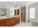 Bathroom with dual vanities, walk-in shower, and updated fixtures at 1441 Gleneagles Dr, Venice, FL 34292