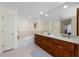 Bathroom with dual vanities, soaking tub, and marble countertops at 1441 Gleneagles Dr, Venice, FL 34292