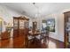 Formal dining room with hardwood floors and elegant wood furniture at 1441 Gleneagles Dr, Venice, FL 34292