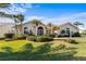 Single-story home with tile roof, lush landscaping, and a large front yard at 1441 Gleneagles Dr, Venice, FL 34292