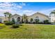 Single-story home with tile roof, lush landscaping, and a large front yard at 1441 Gleneagles Dr, Venice, FL 34292