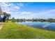 Scenic lake view with lush green landscaping at 1441 Gleneagles Dr, Venice, FL 34292