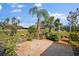 Landscaped backyard with patio and lush greenery at 157 Da Vinci Dr, Nokomis, FL 34275