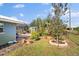 Landscaped backyard with mature trees and shrubs at 157 Da Vinci Dr, Nokomis, FL 34275