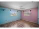 Bedroom with light blue and pink walls and wood floors at 157 Da Vinci Dr, Nokomis, FL 34275