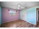 Bedroom with light blue and pink walls and wood floors at 157 Da Vinci Dr, Nokomis, FL 34275