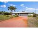 Home exterior showcasing a terracotta driveway and garage at 157 Da Vinci Dr, Nokomis, FL 34275