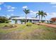 Single-story home with palm trees and a landscaped yard at 157 Da Vinci Dr, Nokomis, FL 34275