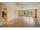 Spacious living room featuring light wood laminate flooring and a ceiling fan at 157 Da Vinci Dr, Nokomis, FL 34275