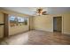 Living room with wood-look floors, large window, and ceiling fan at 157 Da Vinci Dr, Nokomis, FL 34275