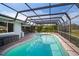 Relaxing pool area with a screened enclosure at 157 Da Vinci Dr, Nokomis, FL 34275