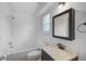 Bright bathroom includes a shower-tub combo, sink and medicine cabinet at 1671 Mellon Way, Sarasota, FL 34232