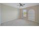 Bedroom featuring a window with blinds, carpeted floors, and a recessed shelf area at 1671 Mellon Way, Sarasota, FL 34232