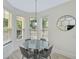 Bright breakfast nook with a round table, four chairs, and a modern pendant light at 1671 Mellon Way, Sarasota, FL 34232