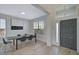 Modern dining area featuring sleek black chairs, light wood floors, and a stylish entryway at 1671 Mellon Way, Sarasota, FL 34232