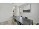 Modern dining room featuring a long dark table with black chairs and minimalist decor at 1671 Mellon Way, Sarasota, FL 34232