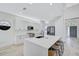 Bright kitchen with white cabinetry, a center island with seating, and stainless steel appliances at 1671 Mellon Way, Sarasota, FL 34232