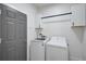 Functional laundry room featuring a modern washer and dryer, white cabinets and neutral door at 1671 Mellon Way, Sarasota, FL 34232