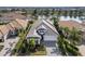 Aerial view of a home with a well-manicured lawn, a pool, and a scenic lake at 16730 Collingtree Xing, Lakewood Ranch, FL 34202