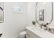 Well-lit bathroom featuring a modern vanity with a sink and a round mirror at 16730 Collingtree Xing, Lakewood Ranch, FL 34202