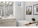 Luxurious bathroom featuring a modern tub, neutral-toned vanity, and stylish fixtures with a framed art piece at 16730 Collingtree Xing, Lakewood Ranch, FL 34202